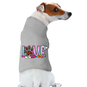 A small brown and white dog wears the Valentine's Day Funny Shirt: Love—a gray tee with “LOVE” on the back, a paw print as the “O,” plus colorful bones and treats—perfect for anyone seeking Valentine’s Day dog shirts.
